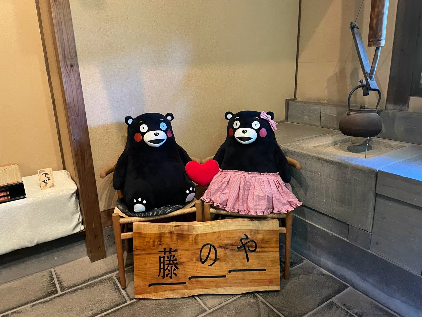 Dos peluches de Kumamon junto al cartel de Fujinoya