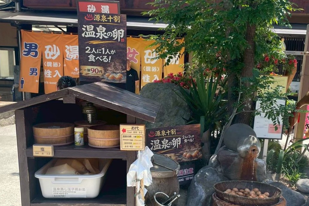 Puesto de huevos de onsen con la cesta en el agua termal